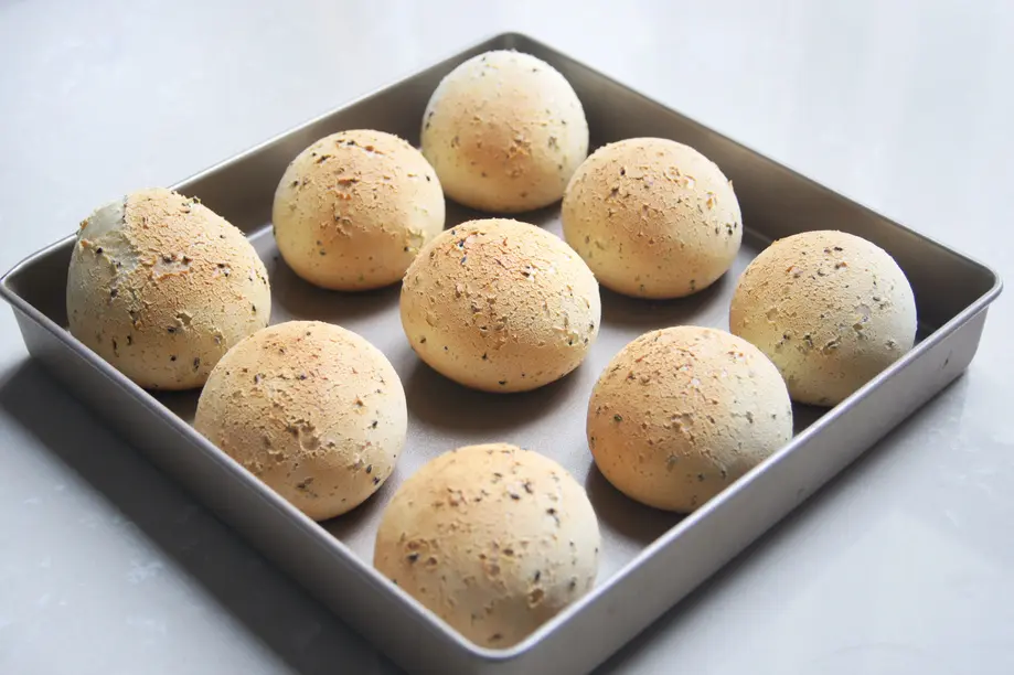 Fresh round buns arranged on a baking tray